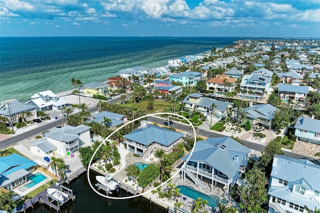 drone / aerial view with a water view and a residential view