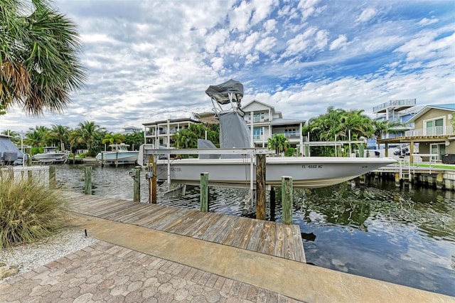 dock area featuring boat lift and a water view