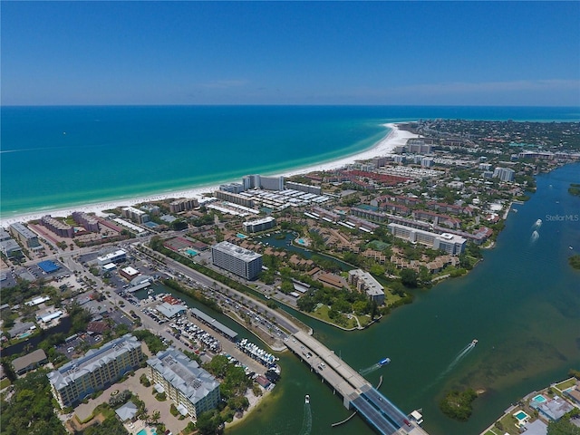 birds eye view of property featuring a water view, a view of city, and a view of the beach