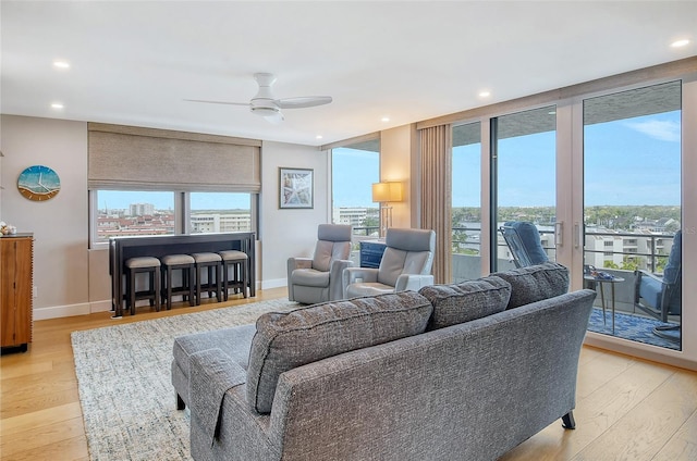 living room with recessed lighting, wood finished floors, baseboards, and ceiling fan