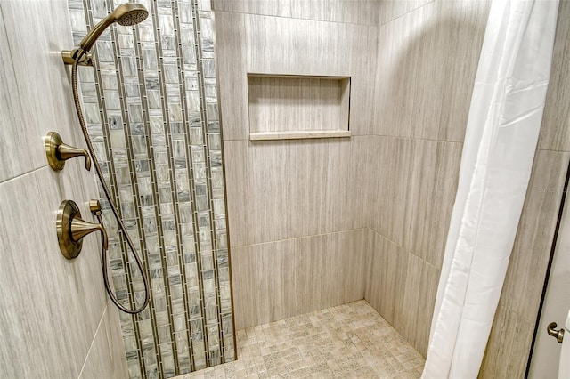 full bath with a tile shower