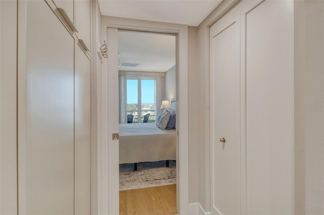 corridor featuring light wood finished floors