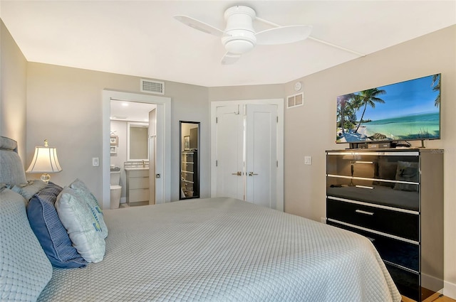 bedroom featuring visible vents, ensuite bath, and a ceiling fan