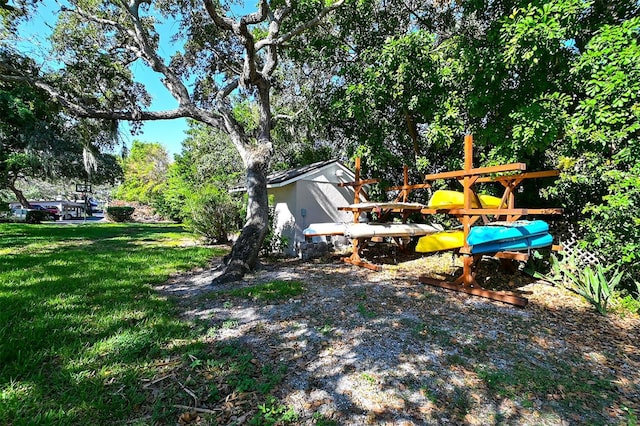 view of yard featuring a storage unit and an outdoor structure