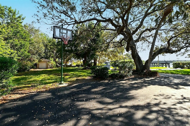 view of basketball court featuring a yard