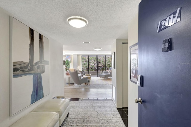 6415 Midnight Pass Rd Unit 211, Sarasota, FL 34242 - hallway with a textured ceiling, tile patterned flooring, and baseboards