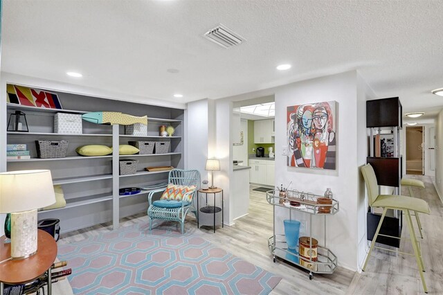 6415 Midnight Pass Rd Unit 211, Sarasota, FL 34242 - living area with light wood-style floors, recessed lighting, baseboards, and a textured ceiling
