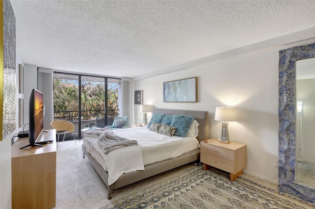 6415 Midnight Pass Rd Unit 211, Sarasota, FL 34242 - carpeted bedroom with a textured ceiling and a wall of windows