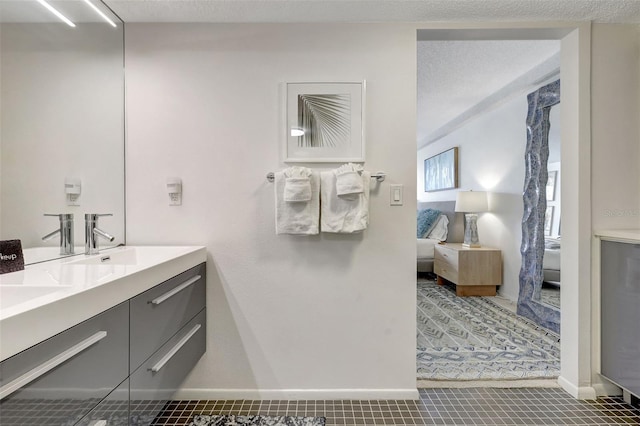 6415 Midnight Pass Rd Unit 211, Sarasota, FL 34242 - ensuite bathroom featuring double vanity, tile patterned floors, and baseboards