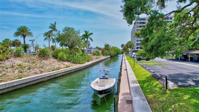 6415 Midnight Pass Rd Unit 211, Sarasota, FL 34242 - surrounding community with a water view and a dock