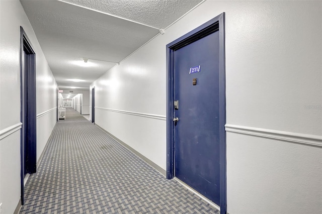 6415 Midnight Pass Rd Unit 211, Sarasota, FL 34242 - corridor featuring a textured ceiling and carpet floors