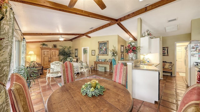 dining space with vaulted ceiling with beams, ceiling fan, light tile patterned flooring, and visible vents