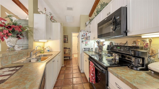 kitchen featuring stone tile floors, visible vents, black appliances, white cabinetry, and a sink