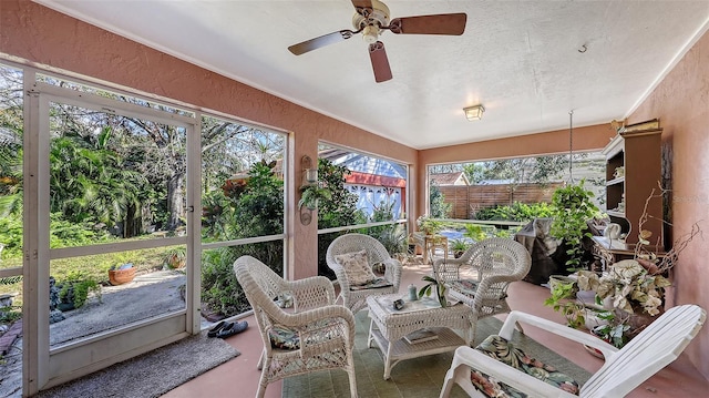 sunroom featuring a ceiling fan