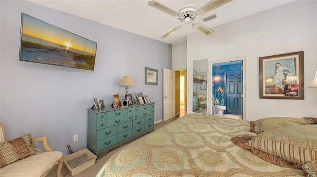 carpeted bedroom featuring ensuite bathroom, visible vents, and a ceiling fan