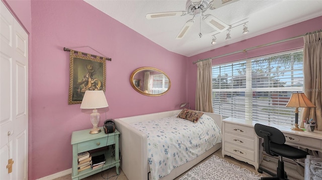 bedroom with ceiling fan and track lighting