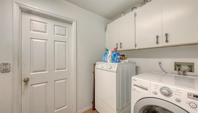 clothes washing area featuring cabinet space and washing machine and clothes dryer