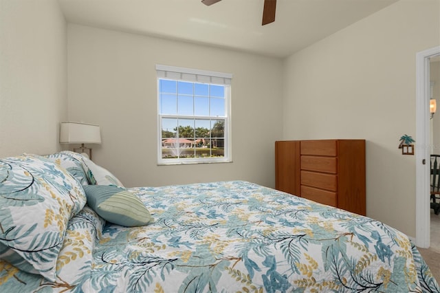 carpeted bedroom with ceiling fan and baseboards