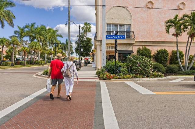 exterior space with curbs, sidewalks, and street lights