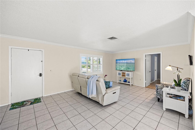 living area with ornamental molding, visible vents, a textured ceiling, and light tile patterned floors