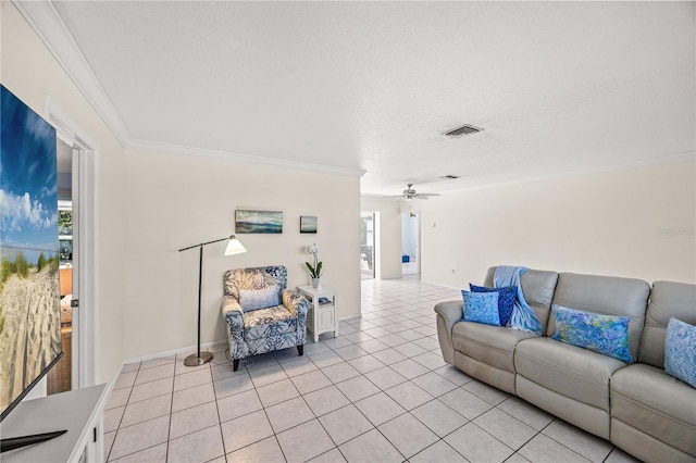 living room with light tile patterned floors, visible vents, a ceiling fan, ornamental molding, and a textured ceiling