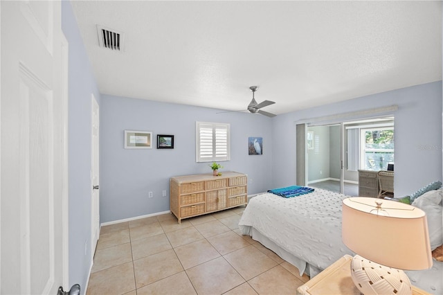 bedroom featuring multiple windows, visible vents, a ceiling fan, and light tile patterned flooring