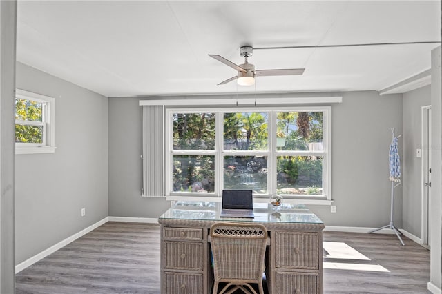 office area featuring light wood finished floors, baseboards, and a ceiling fan