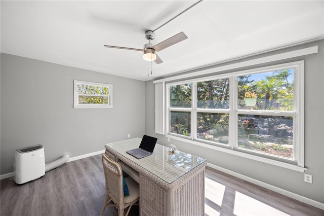 office featuring a ceiling fan, light wood-style flooring, and baseboards