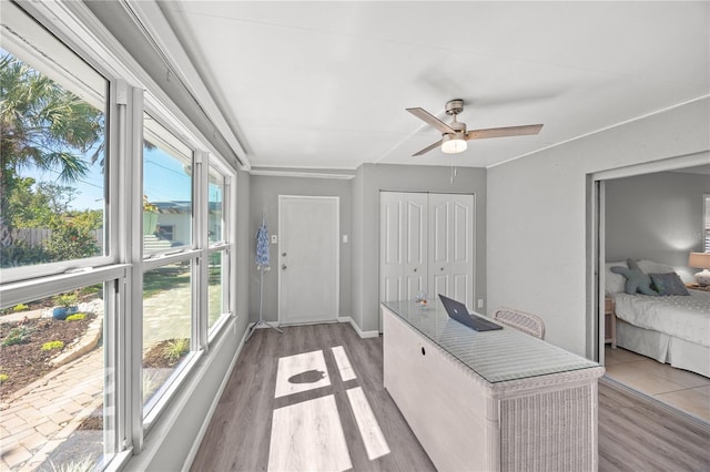 sunroom featuring a ceiling fan