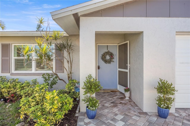 view of exterior entry featuring stucco siding