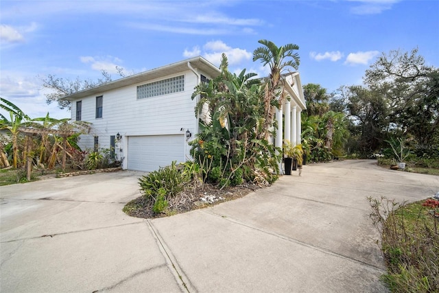 view of side of home featuring a garage