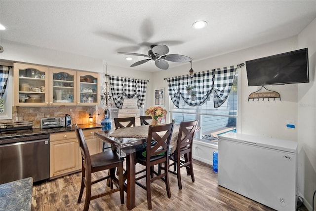 dining area with ceiling fan, dark hardwood / wood-style flooring, and a textured ceiling