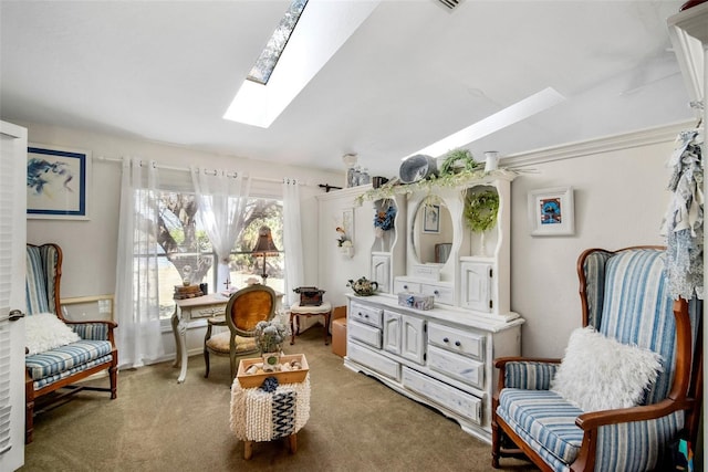 living area featuring vaulted ceiling with skylight and carpet