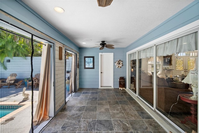 sunroom / solarium with ceiling fan