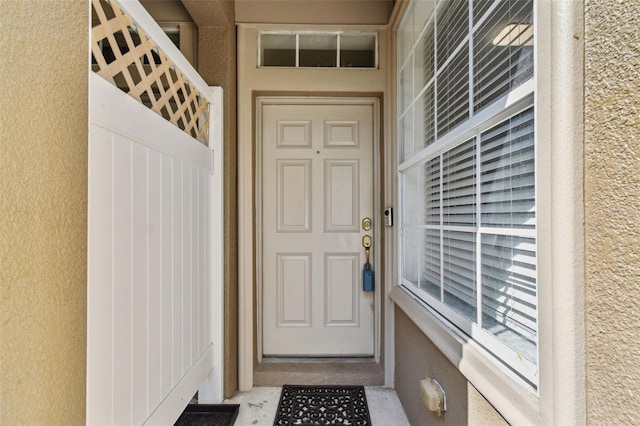 entrance to property with stucco siding