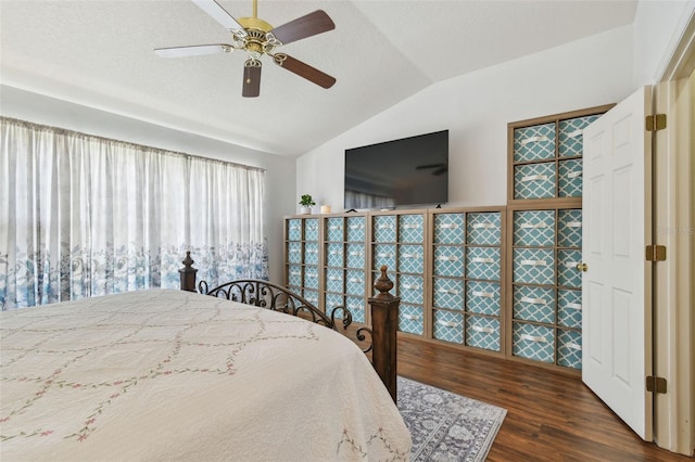 bedroom featuring dark wood-style floors, lofted ceiling, a textured ceiling, and a ceiling fan