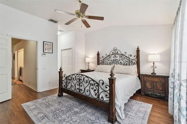 bedroom with visible vents, a ceiling fan, vaulted ceiling, a closet, and dark wood-style floors