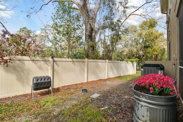 view of yard with fence and central air condition unit