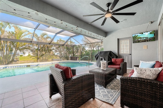 view of swimming pool featuring a grill, an outdoor hangout area, glass enclosure, and a patio area