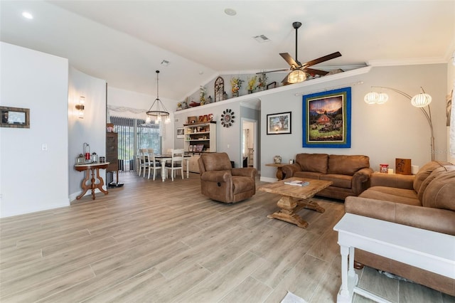 living room featuring lofted ceiling, light hardwood / wood-style flooring, ornamental molding, and ceiling fan