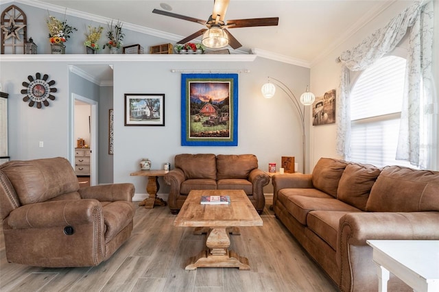 living room featuring ornamental molding, lofted ceiling, ceiling fan, and light hardwood / wood-style flooring