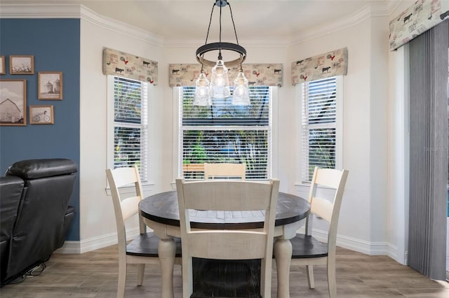 dining space with ornamental molding, light hardwood / wood-style floors, and plenty of natural light