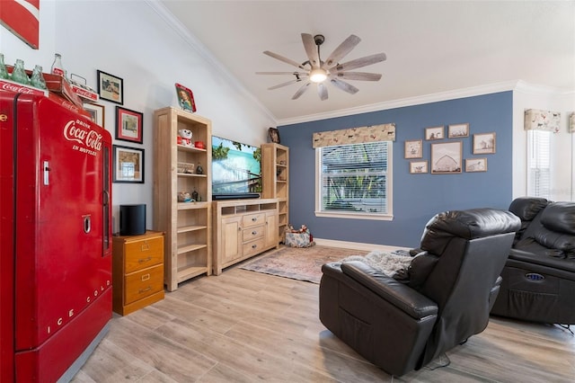 living room with crown molding, light hardwood / wood-style flooring, and ceiling fan