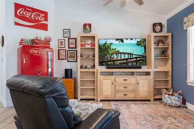 living room with crown molding, ceiling fan, and light hardwood / wood-style flooring