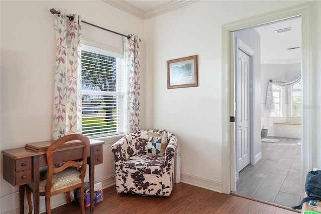 living area featuring crown molding and hardwood / wood-style floors