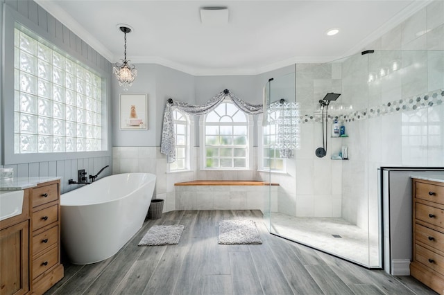 bathroom featuring tile walls, crown molding, separate shower and tub, and hardwood / wood-style flooring