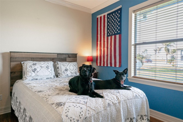 bedroom with hardwood / wood-style floors and crown molding