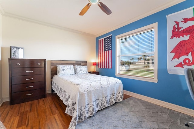 bedroom featuring crown molding, dark wood-type flooring, and ceiling fan