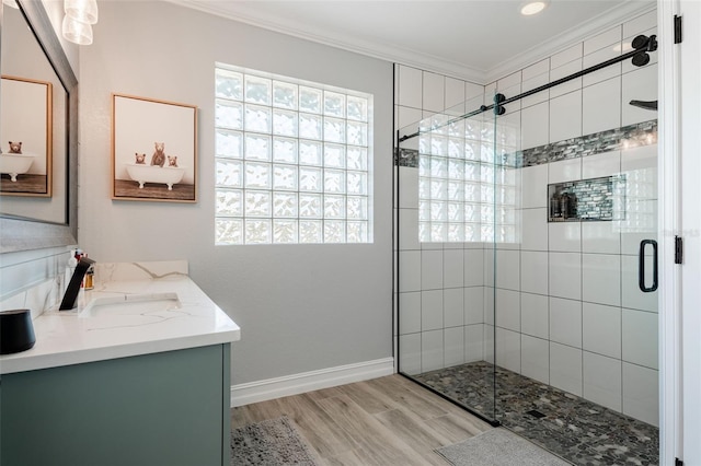 bathroom featuring crown molding, vanity, a shower with door, and hardwood / wood-style flooring