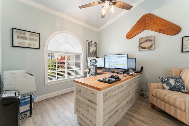 office space featuring light hardwood / wood-style flooring, ornamental molding, ceiling fan, and vaulted ceiling